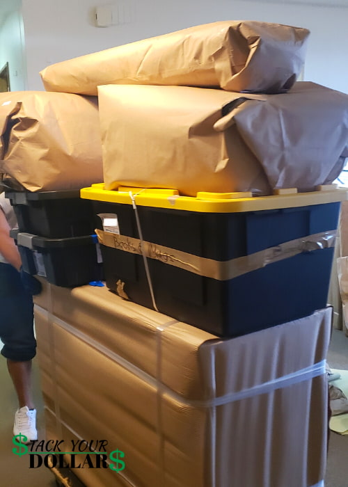 Stacked items wrapped in brown paper and yellow-lid bin